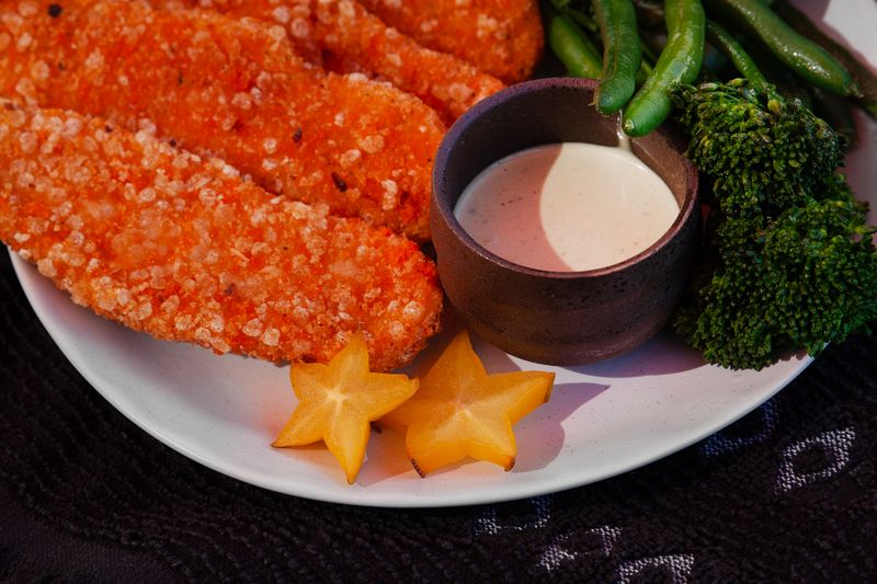 Crispy golden chicken strips with dipping sauce
