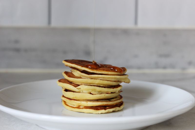 Wholesome pancake stack with fresh fruit and maple syrup